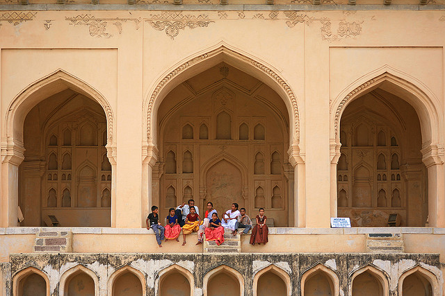 a group of people posing for a picture in front of a building