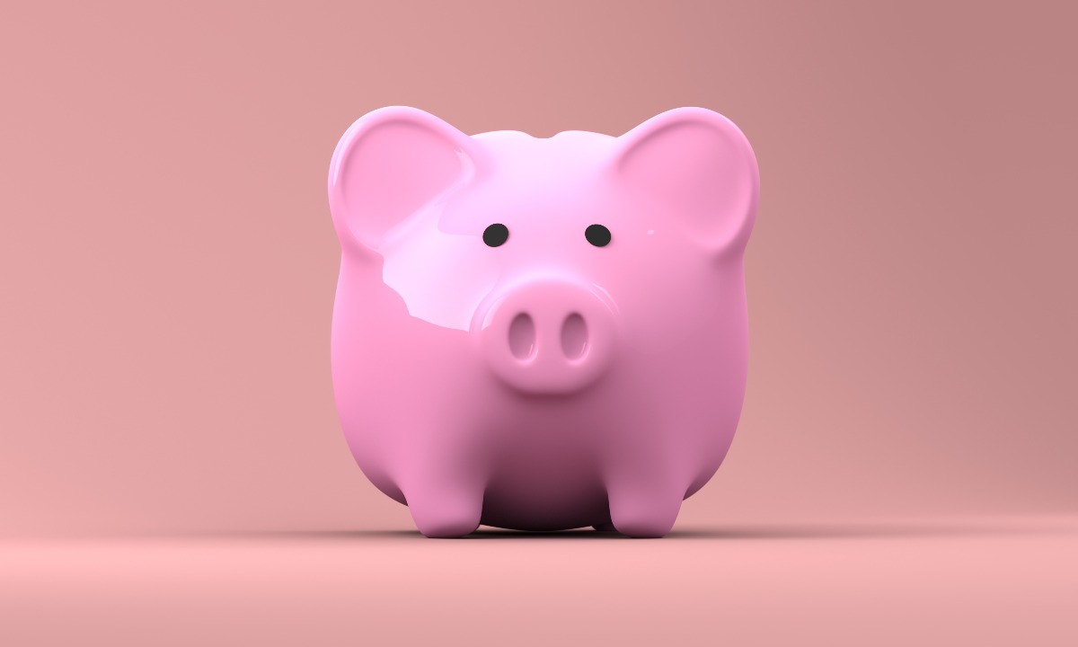 a pink piggy bank on a red background