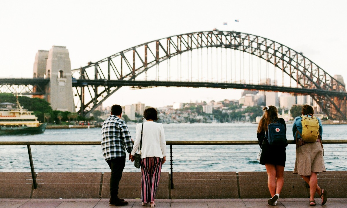 a group of people looking at a bridge