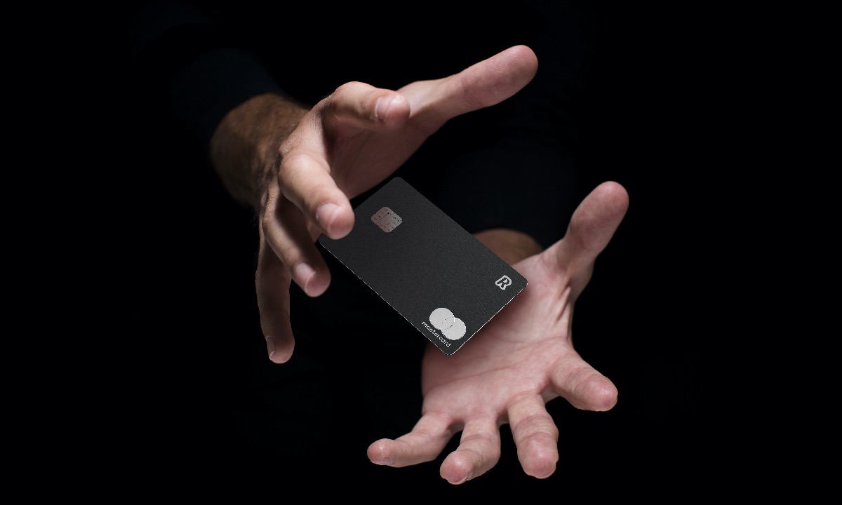 a pair of hands holding a black rectangular object