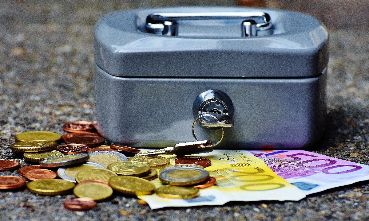 a silver and black briefcase with coins