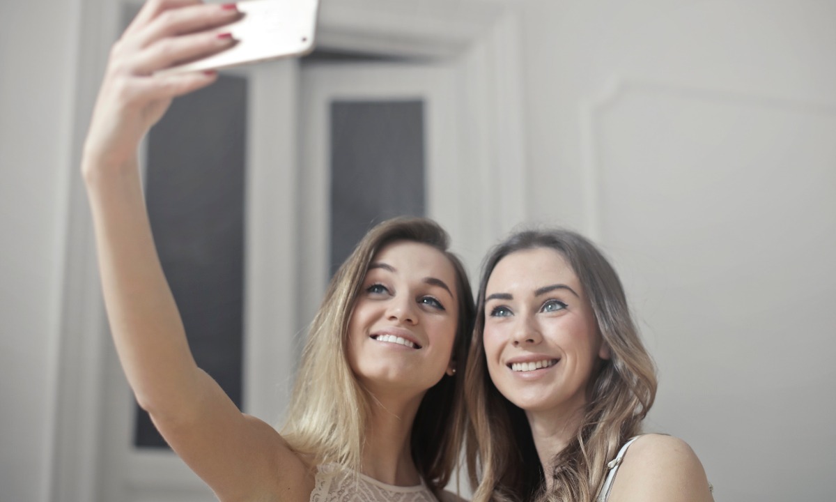 a couple of women taking a selfie