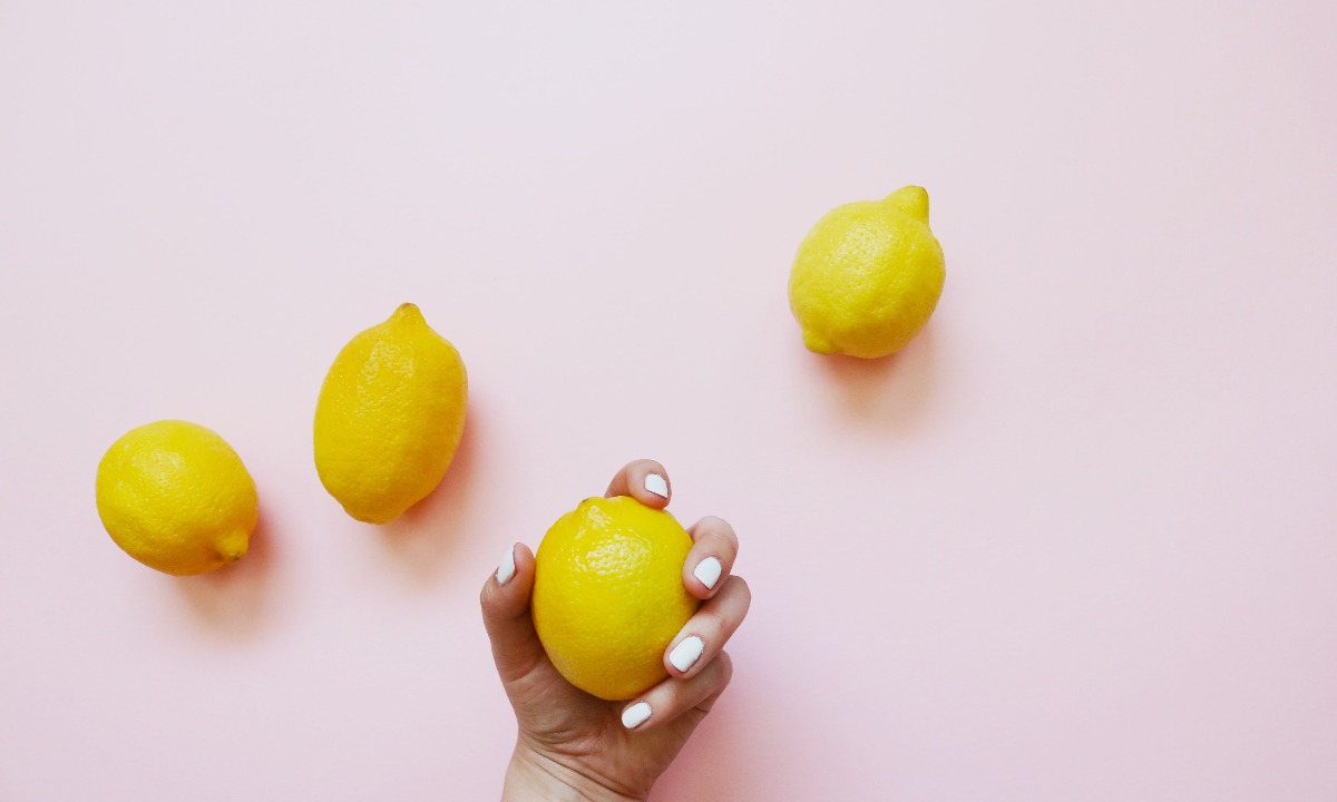 a hand holding a lemon