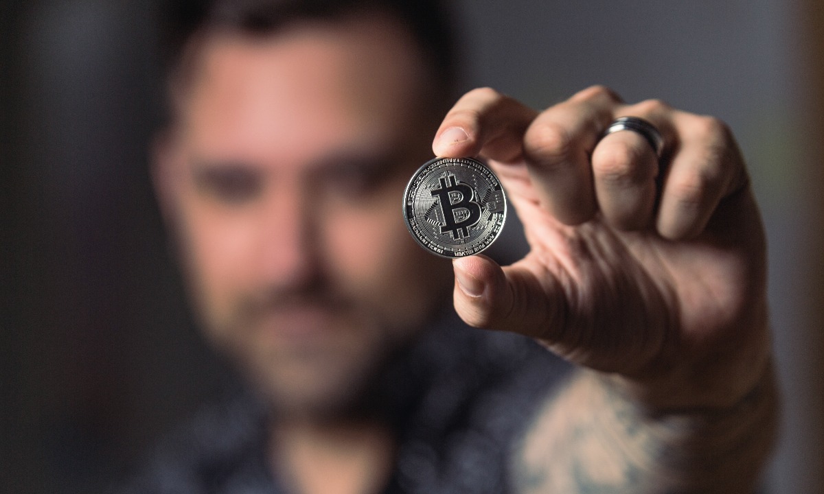 a man holding a coin
