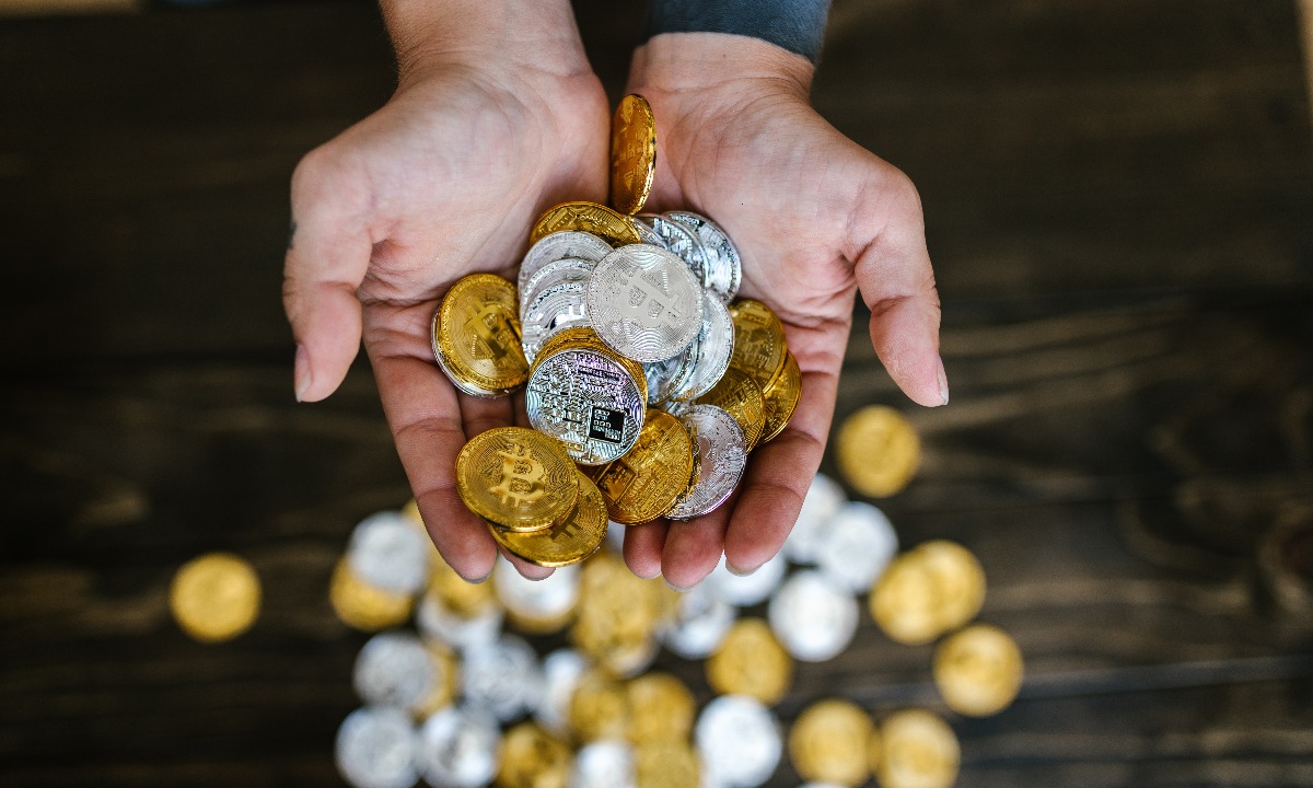 a person holding a handful of coins