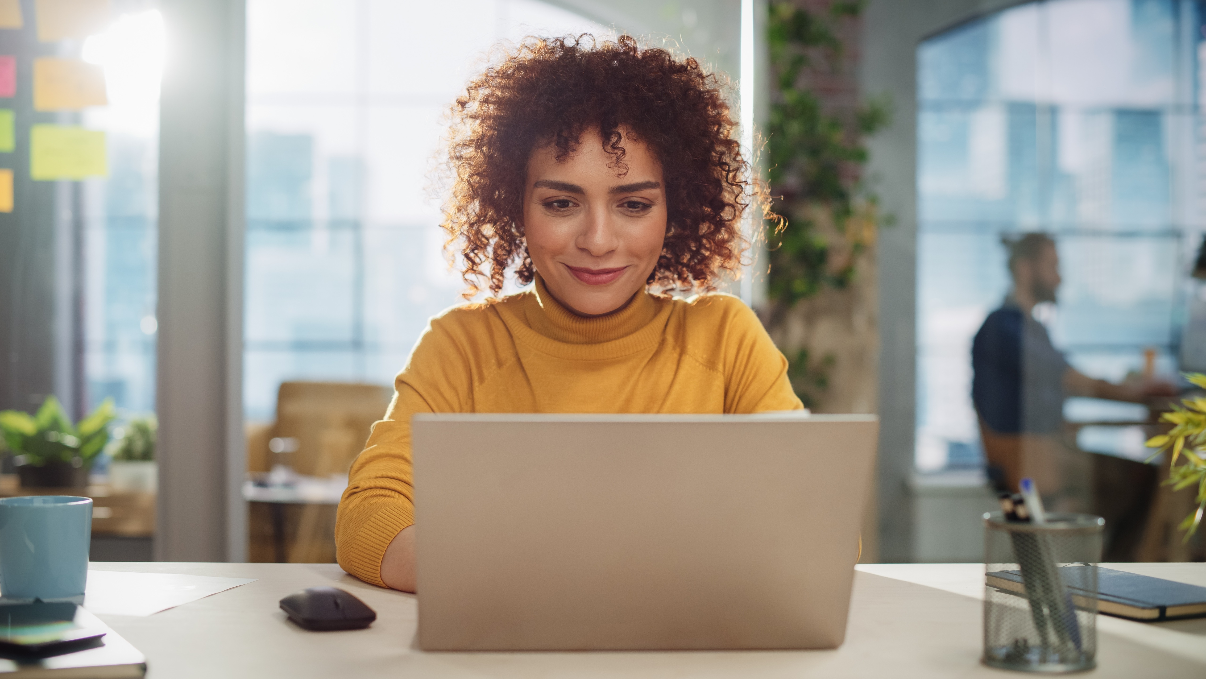 Stock woman with laptop / Shutterstock