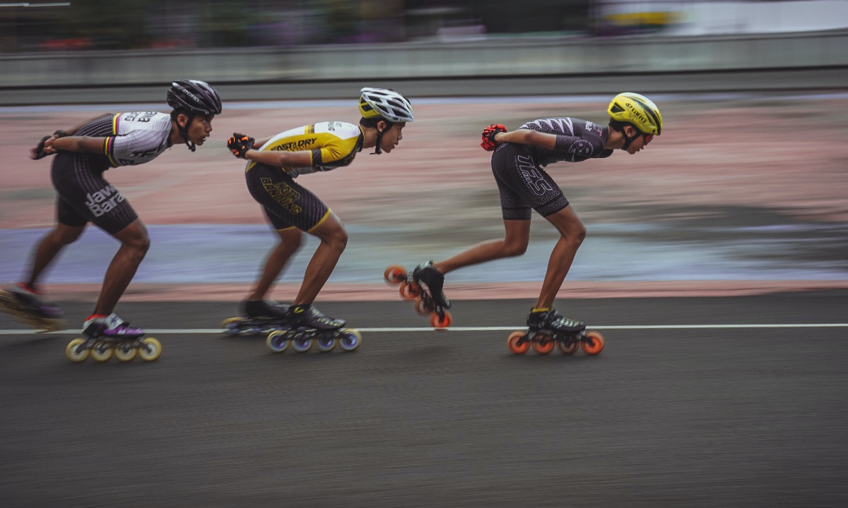 a group of people racing on skateboards