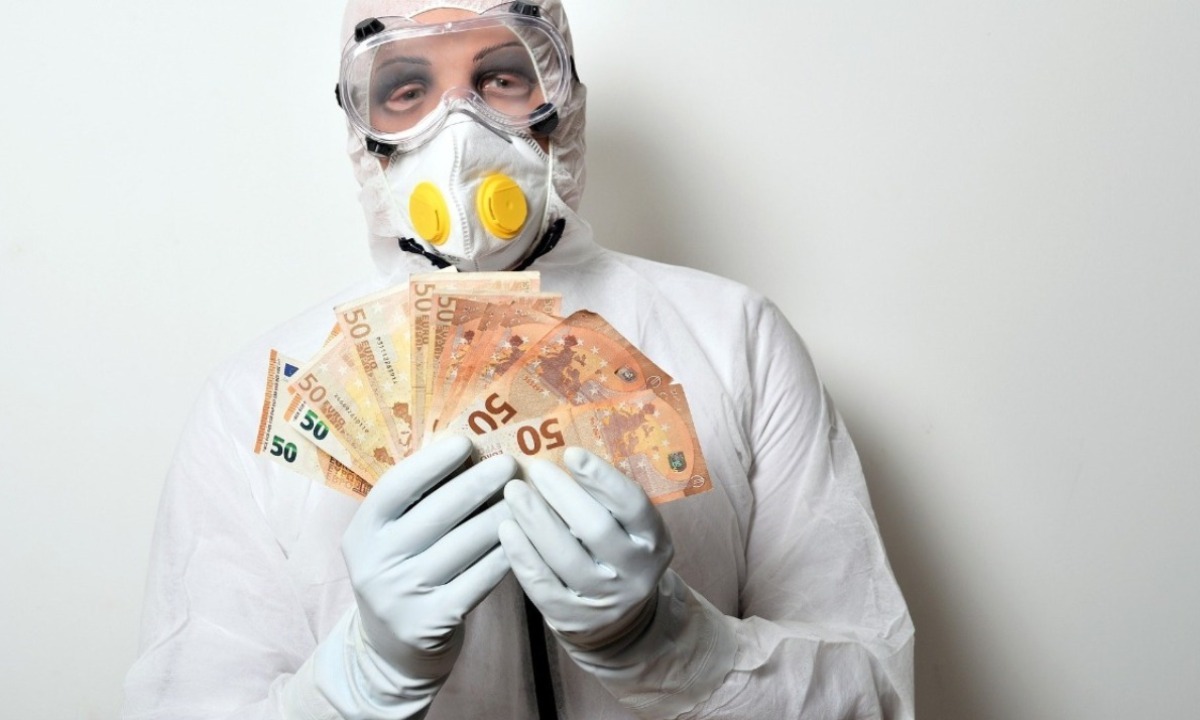 a person in a mask holding money