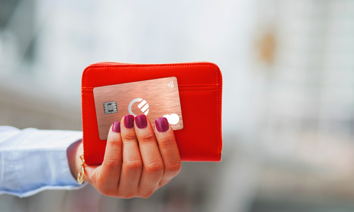 a hand holding a red wallet