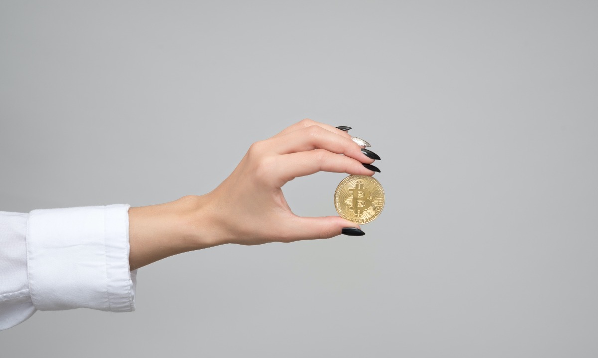a hand holding a coin