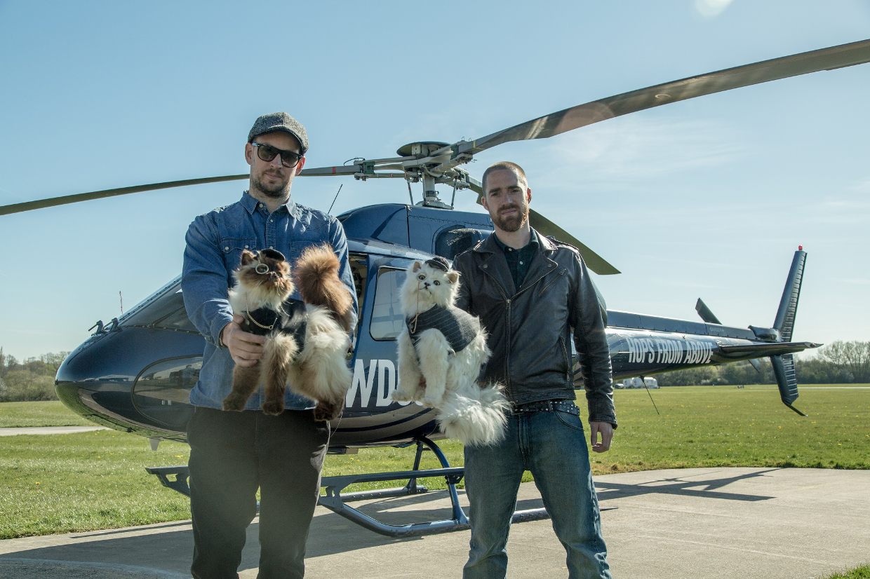 a couple of men with a helicopter and a dog