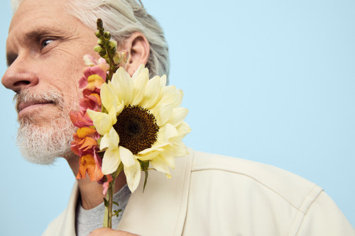 Man holding a bouquet of flowers