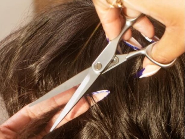 A stylist trimming hair