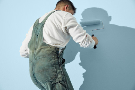 Painting contractor painting the wall blue