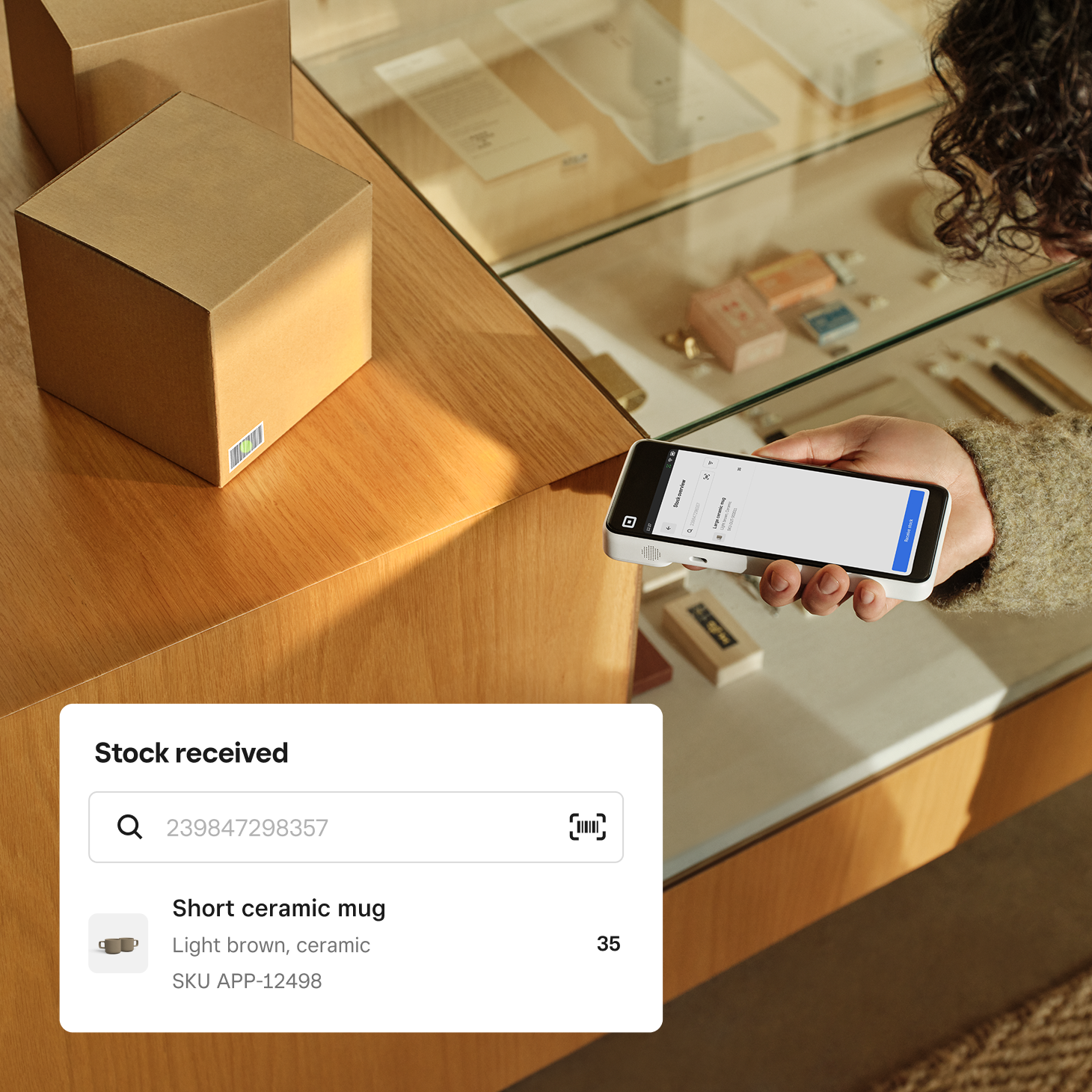 Person scanning a barcode using the Square Handheld. 