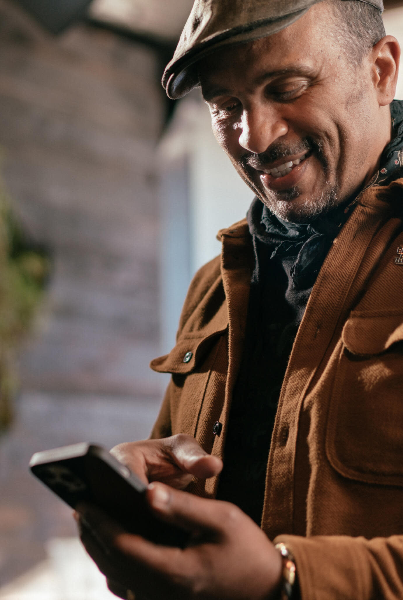 Red Bay Coffee founder Keba Konte using a smartphone.