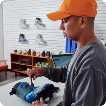 Them Skates shop owner Jon Julio lacing rollerblades
