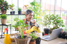 Shop owner selling plants via livestream video. 