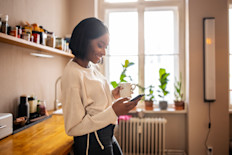 Woman using a mobile phone at home.