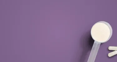 a purple background with a scoop of powder