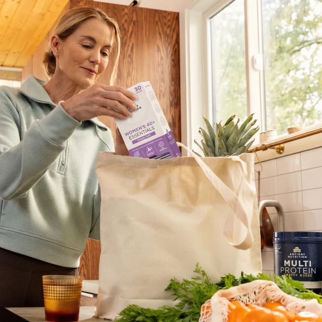 a woman unloading a grocery bag