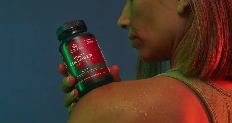 a woman with a bottle of Multi Collagen Advanced Lean capsules