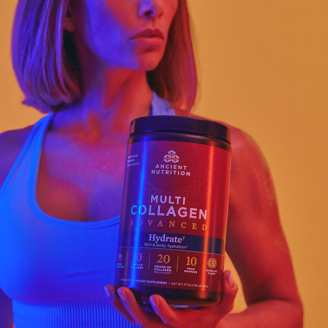a women holding a tub of collagen