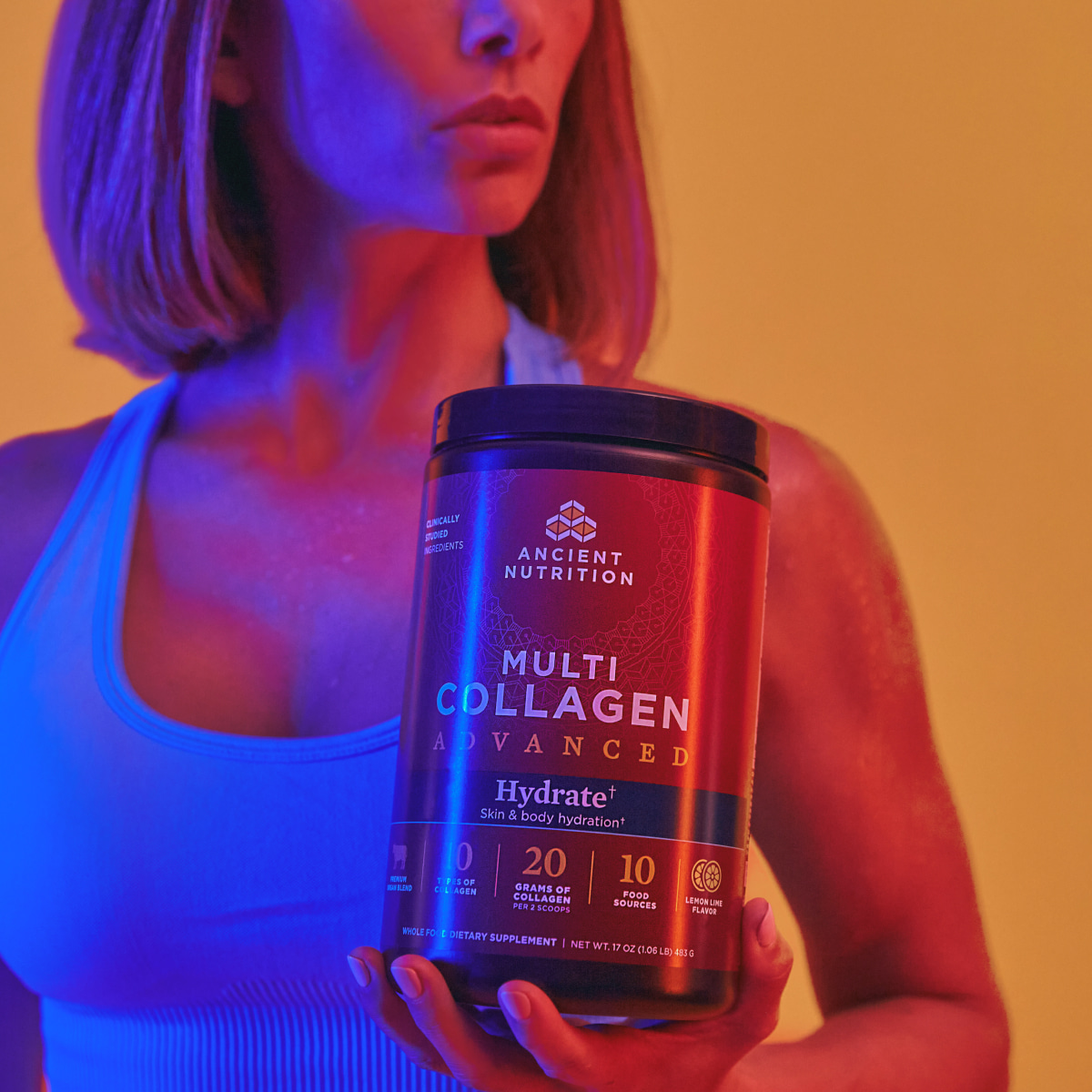 a women holding a tub of collagen