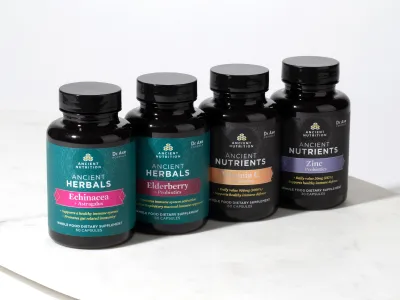 4 supplement bottles in a row on a counter