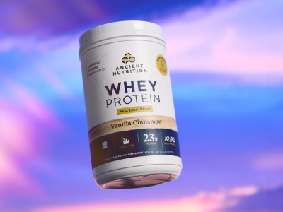 a bottle of whey protein + fat loss on a colored background