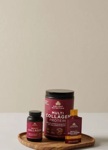 Multi collagen protein powder, capsules and gel pack on a wood tray