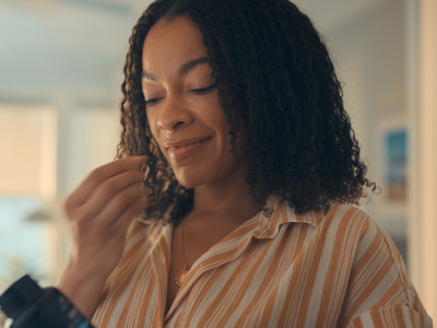 woman taking sbo probiotic capsule