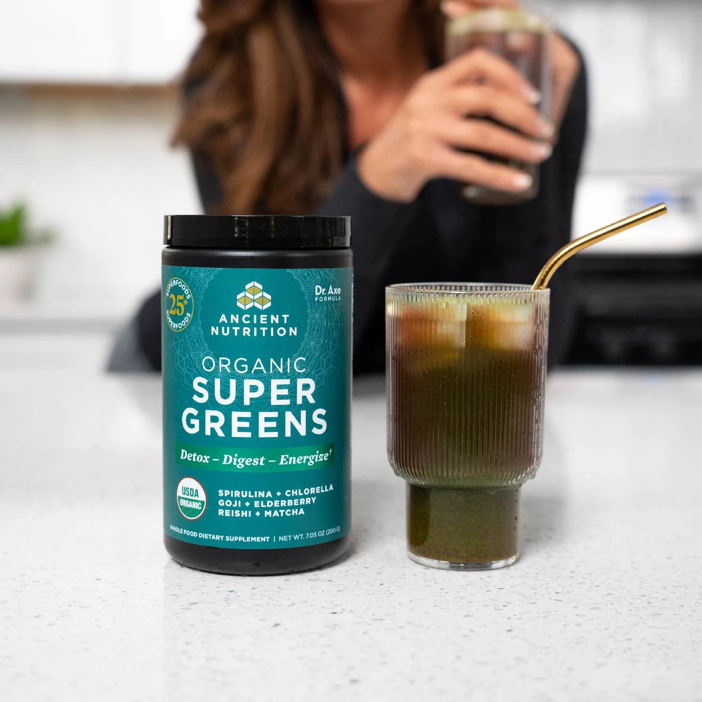 a glass of organic supergreens on a kitchen counter