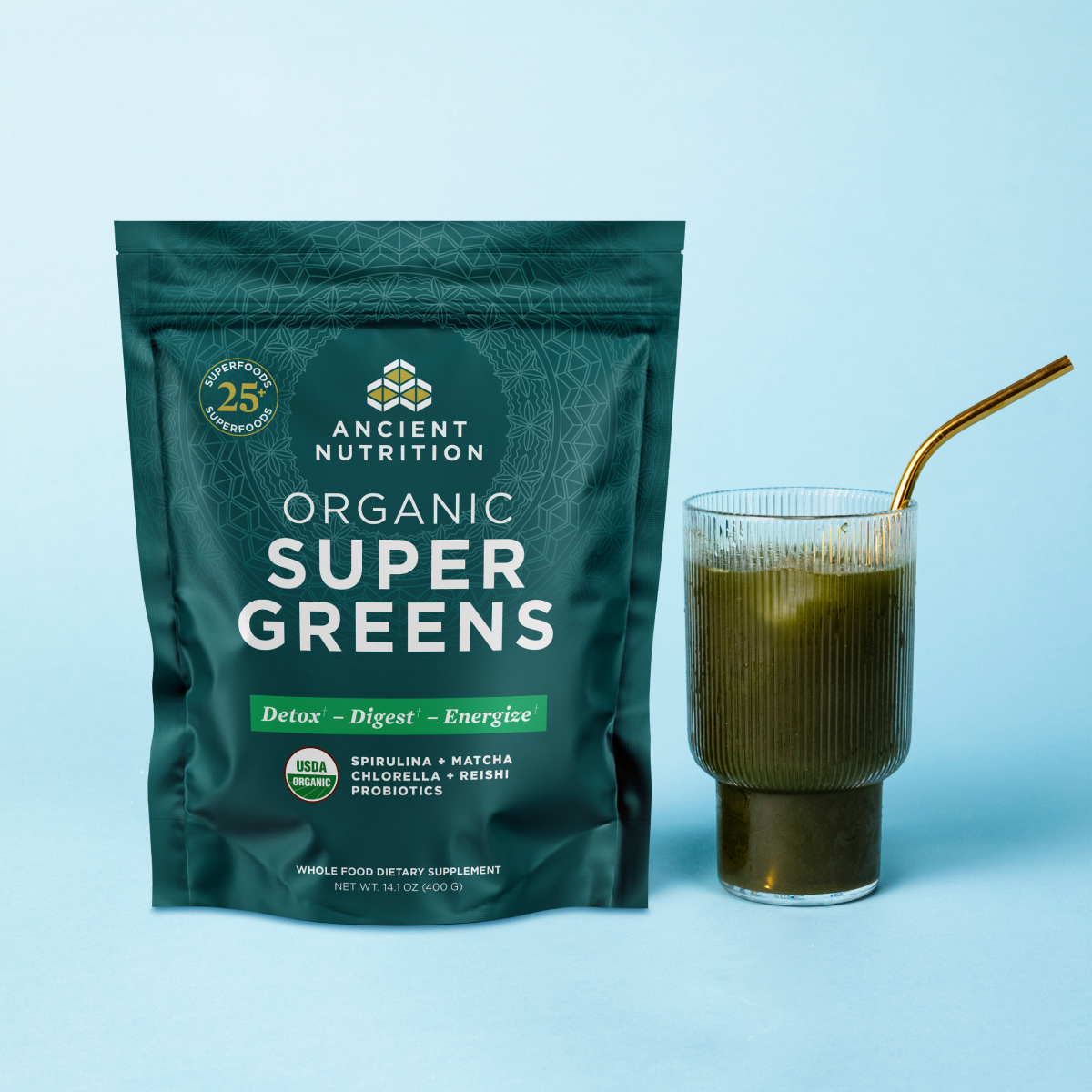 supergreens bag next to a glass of greens