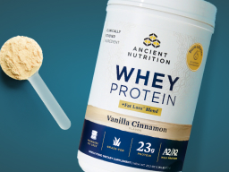 Whey Protein Powder Fat Loss + Scoop with teal background 