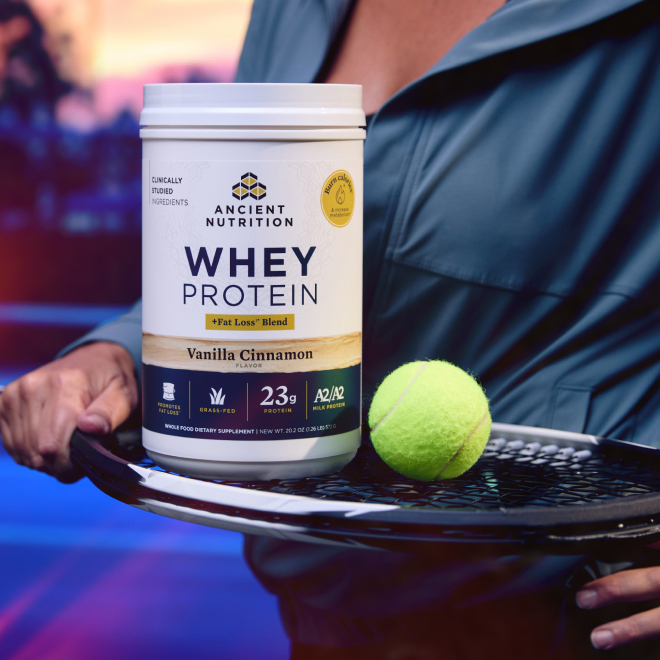 bottle of Whey Protein powder fat loss on a tennis racquet