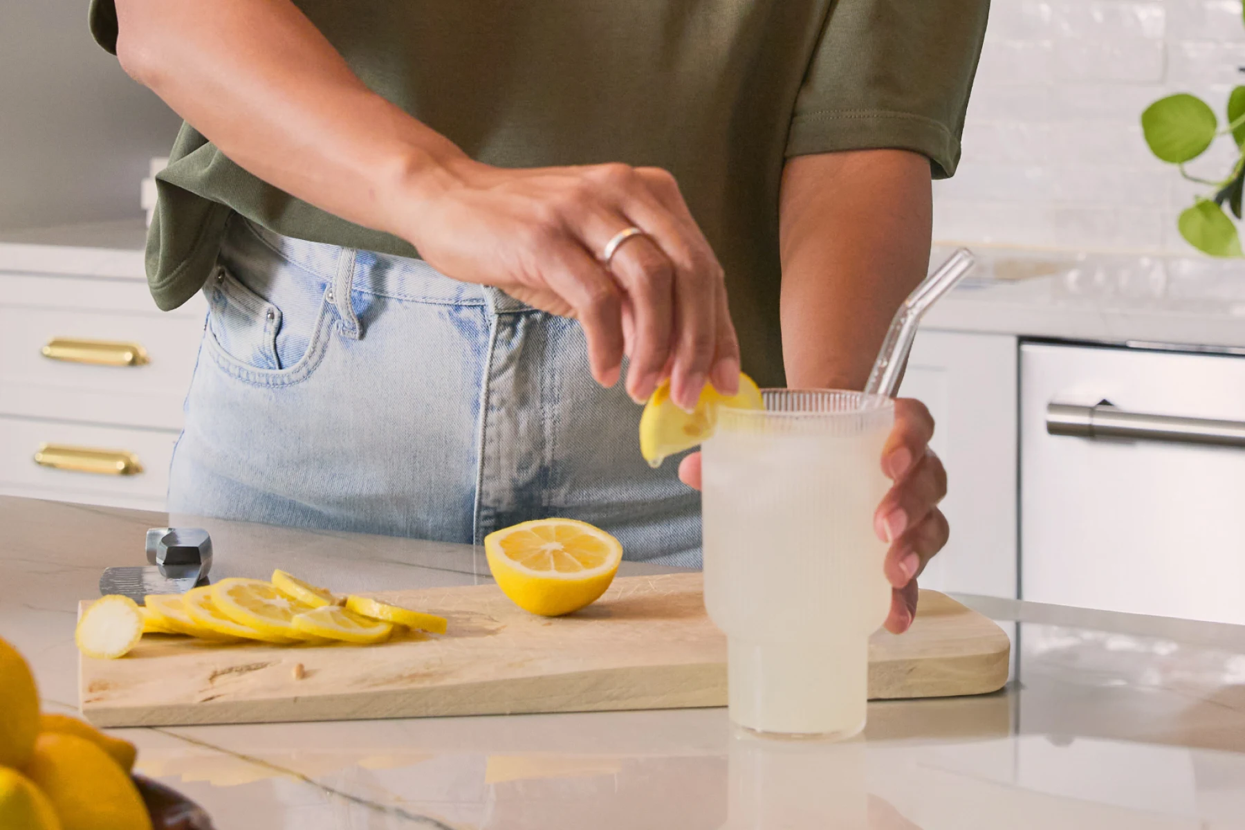 a person with a glass of lemon water