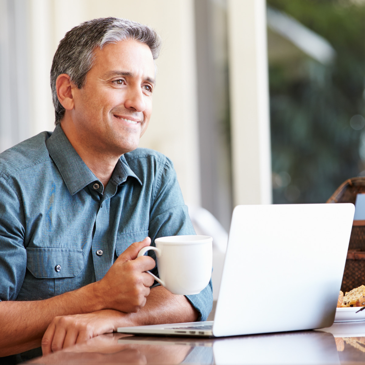 man sitting at desk with a computer