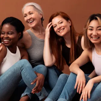 four woman sitting and laughing
