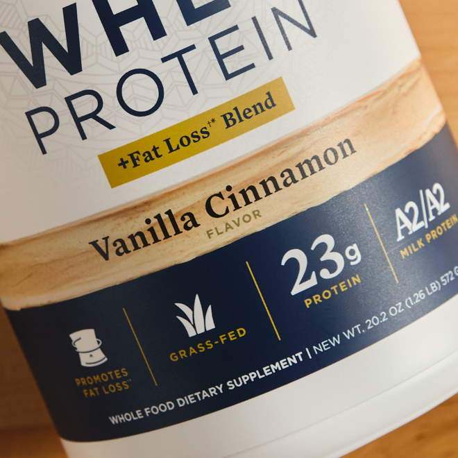 a bottle of whey protein vanilla up close