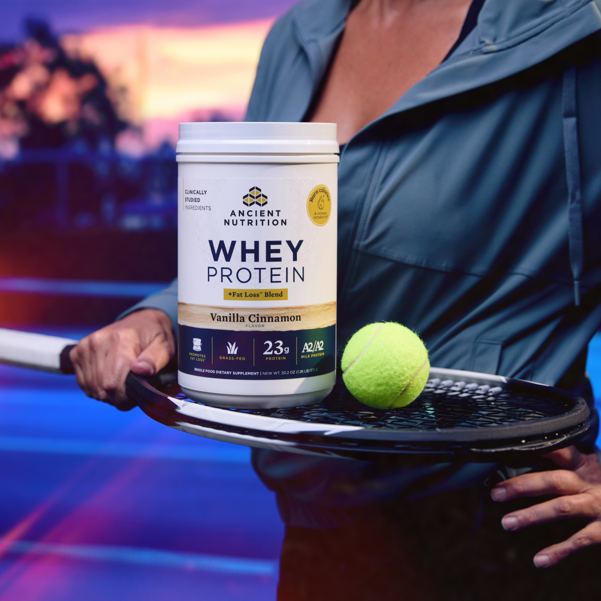 bottle of Whey Protein powder fat loss on a tennis racquet