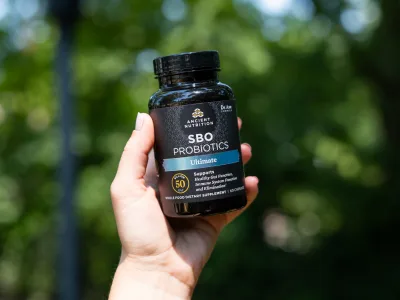 SBO probiotics bottle in hand
