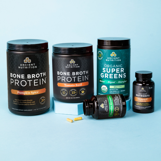 Bottles of Ancient Nutrition Bone Broth Protein, Organic SuperGreens, and Vitamins on a blue background