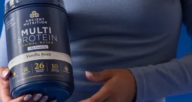 a person holding a bottle of Multi Protein + Creatine Vanilla Bean 