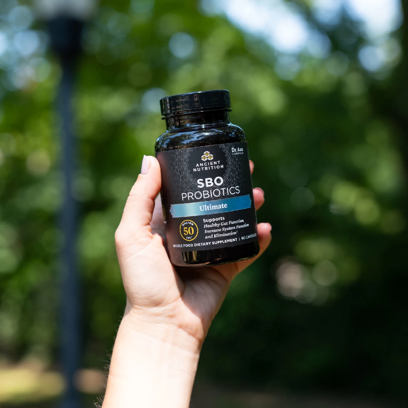 a person holding a bottle of SBO Probiotics Ultimate