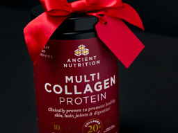 bottle of multi collagen protein powder with a red ribbon on top