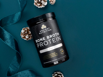 bottle of bone broth protein on a navy background