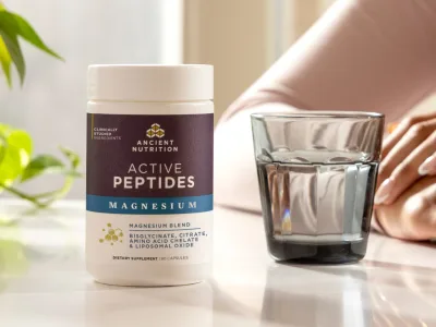 Active Peptides Magnesium next to a glass of water