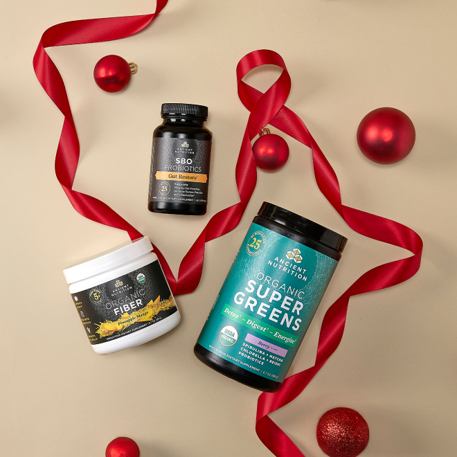 Supergreens, fiber, and sbo probiotics on tan holiday background