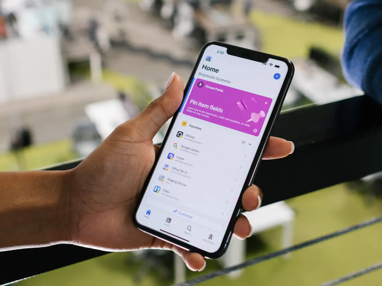 Person holding phone - find the perfect password manager